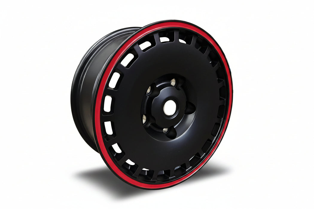 A black multi-spoke aftermarket car wheel rim with a thin red outer lip, 